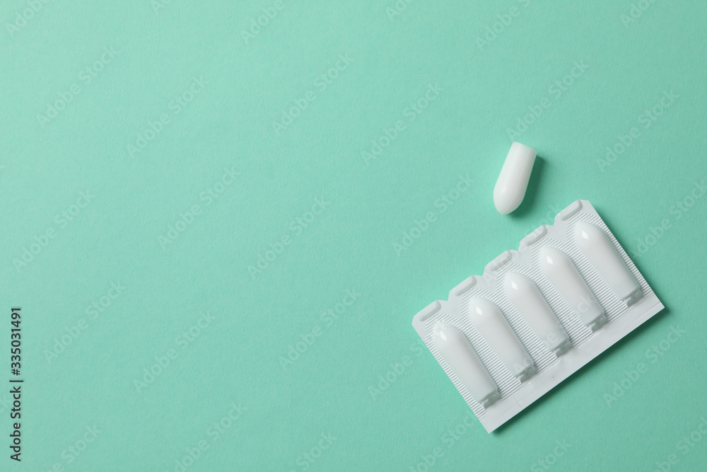 Anal or vaginal candles on mint background, top view Anal or vaginal candles on mint background, top view