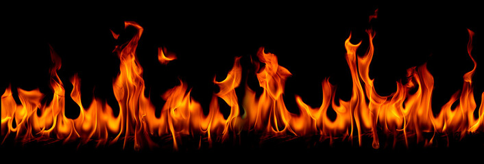 On fire flames at the black background, Burning red hot sparks rise, Fiery orange glowing flying particles