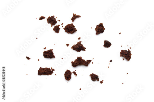 Crumbs of Chocolate brownie with sliced almond nuts toppings isolated on white background.