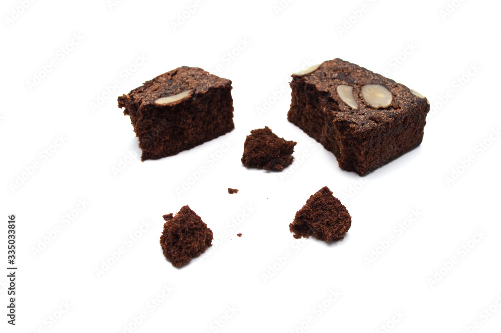 Chocolate brownie with sliced almond nuts toppings crumbs isolated on white background. Chocolate brownie with sliced almond nuts toppings crumbs isolated on white background.