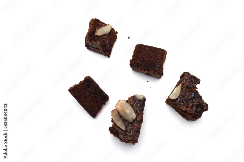 Chocolate brownie with sliced almond nuts toppings crumbs isolated on white background. Chocolate brownie with sliced almond nuts toppings crumbs isolated on white background.