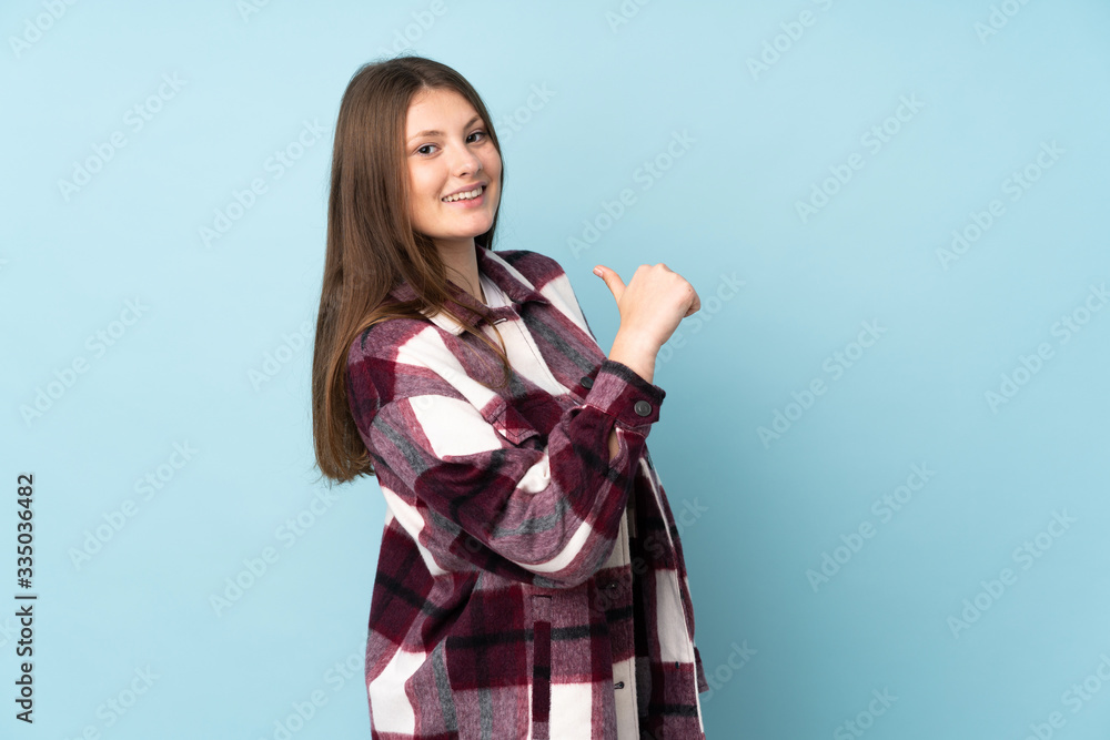 Teenager caucasian girl isolated on blue background proud and self-satisfied Teenager caucasian girl isolated on blue background proud and self-satisfied
