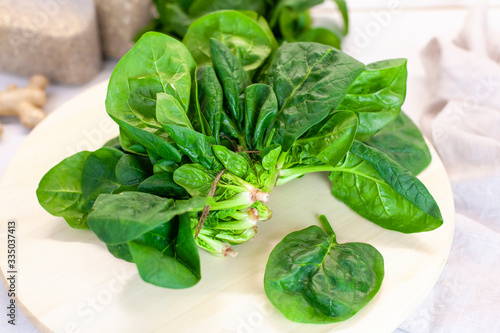 Close-up of spinach on the kitchen table on a light background