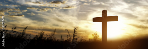 Silhouette of catholic cross at sunset background. panorama picture