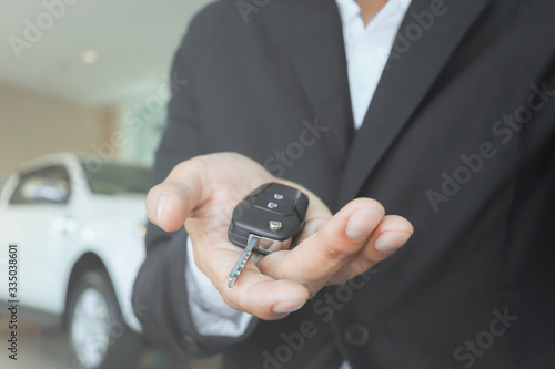 Male salesman holding car keys