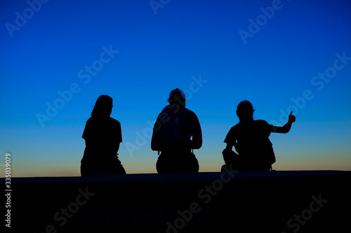 Family at Sunrise or Sunset Together with Thumbs Up