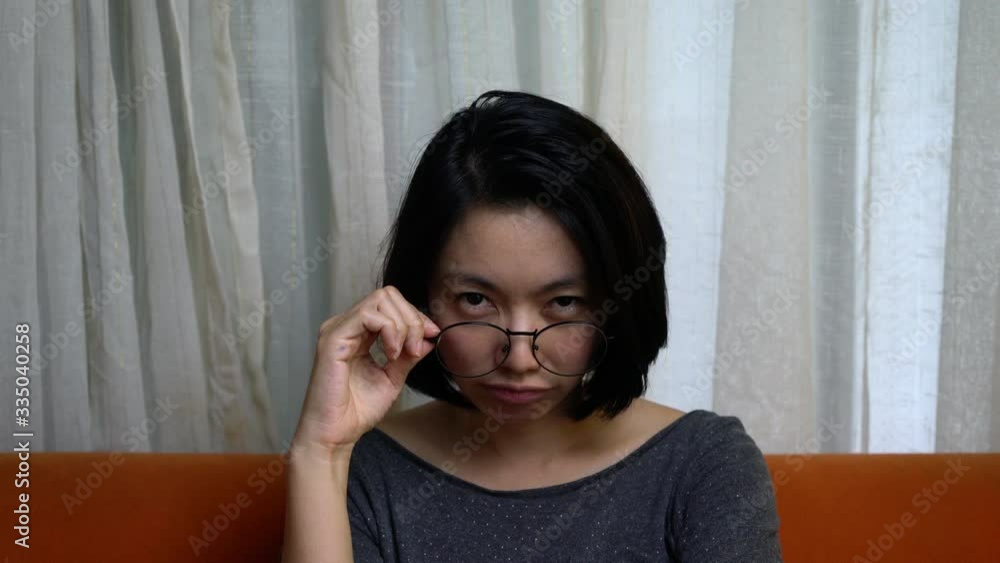 Happy woman wearing eye glasses and talking video call on chat smiling and shy Happy woman wearing eye glasses and talking video call on chat smiling and shy