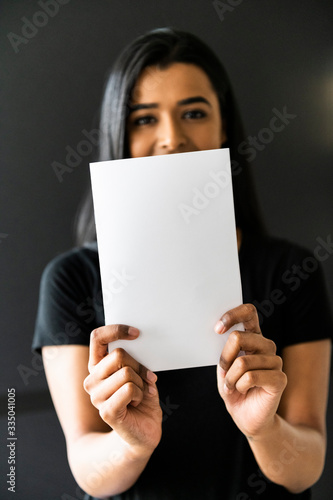 Woman of color holding a blank A5