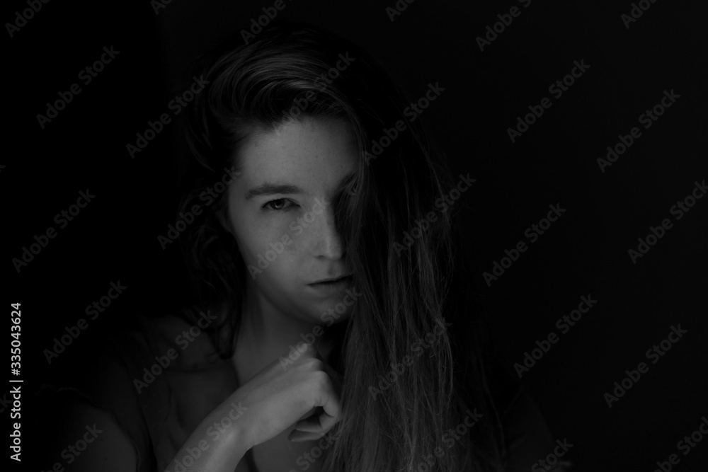 Black and white image of Ginger hair young white model with black background