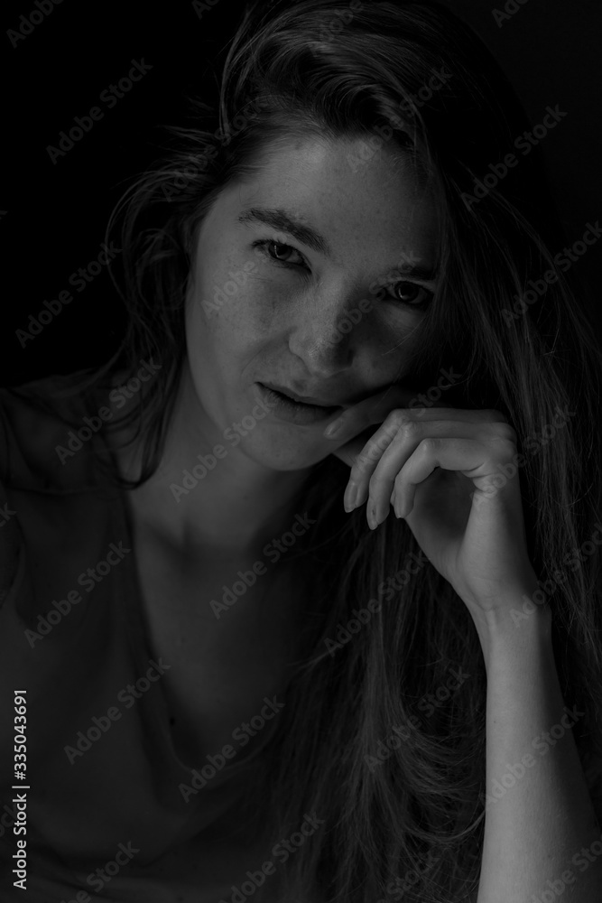 Black and white image of Ginger hair young white model with black background Black and white image of Ginger hair young white model with black background