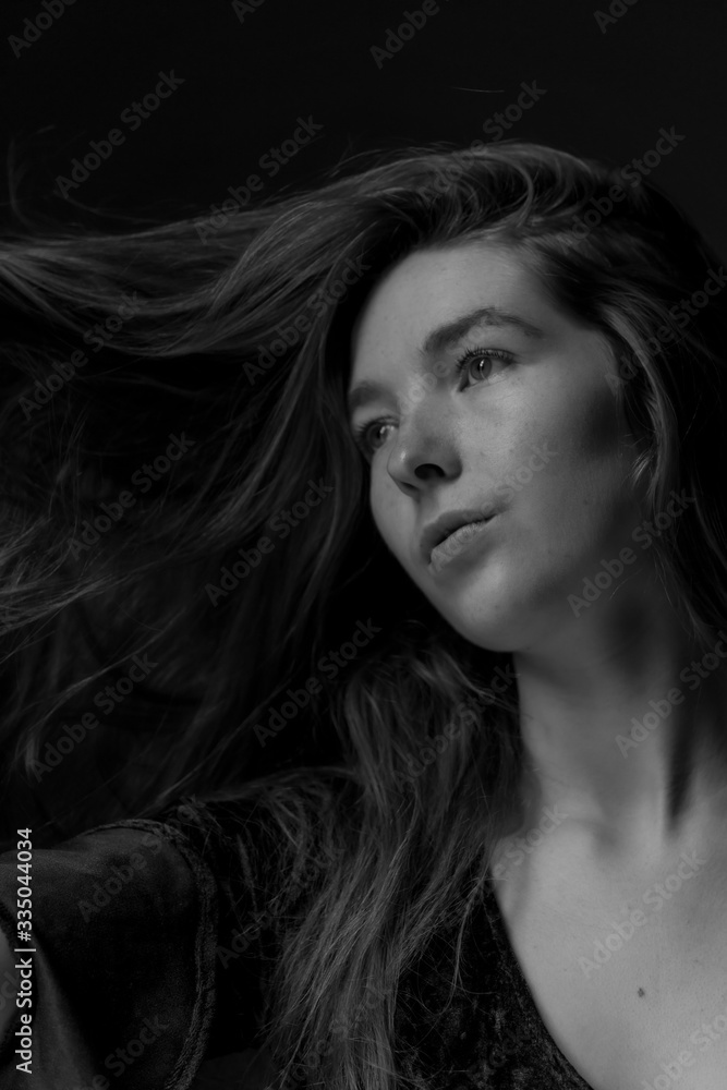 Black and white image of Ginger hair young white model with black background Black and white image of Ginger hair young white model with black background