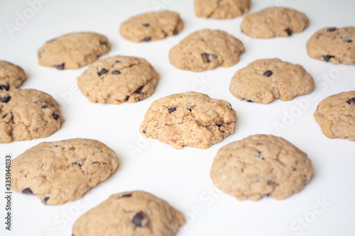 Homemade chocolate cookies in rows on a white background