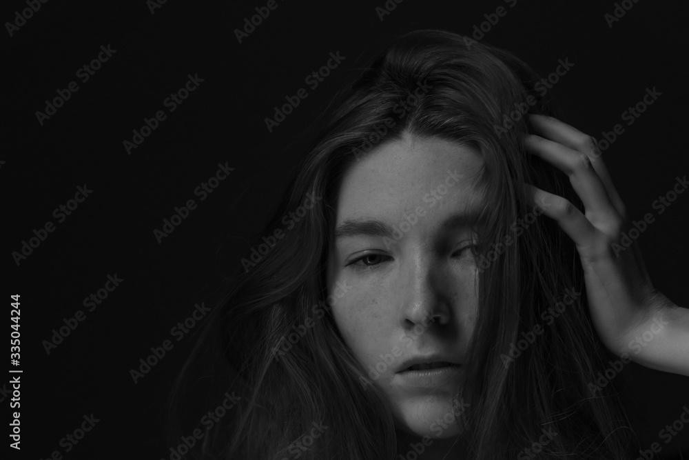 Black and white image of Ginger hair young white model with black background Black and white image of Ginger hair young white model with black background
