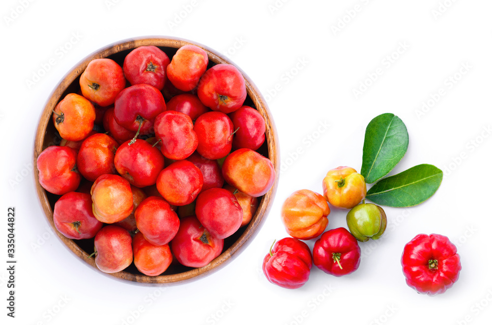 Closeup fresh small red organic acerola cherry fruit (Malpighia Glabra) with green leaf in wooden bowl isolated on white background. Closeup fresh small red organic acerola cherry fruit (Malpighia Glabra) with green leaf in wooden bowl isolated on white background.