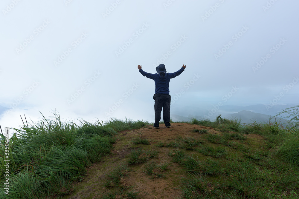 Man traveler on cliff with beautiful foggy in national park. Man traveler on cliff with beautiful foggy in national park.