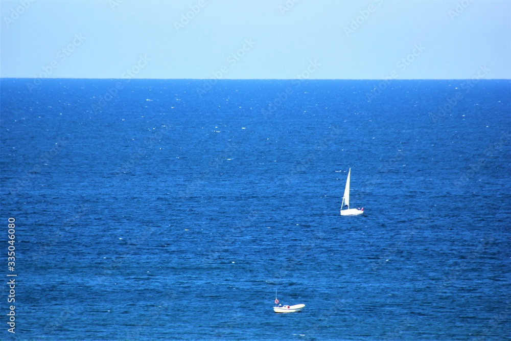 white boats in blue see