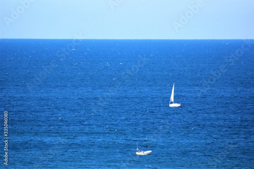 white boats in blue see