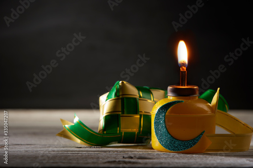 oil lamp or pelita  with ketupat for ramadan celebration photo