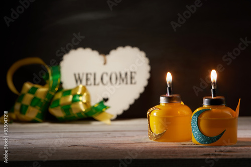 oil lamp or pelita  with ketupat for ramadan celebration photo