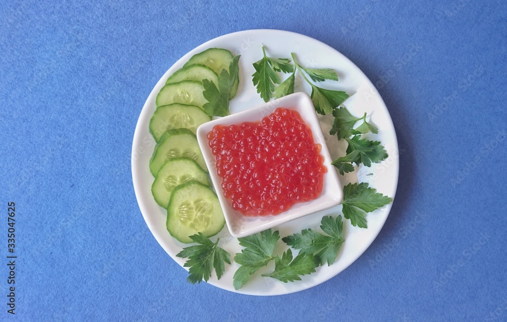 Red caviar of salmon fish, cucumber, parsley. Red caviar of salmon fish, cucumber, parsley.