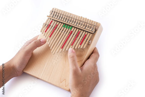 Hand play kalimba isolated on white. photo