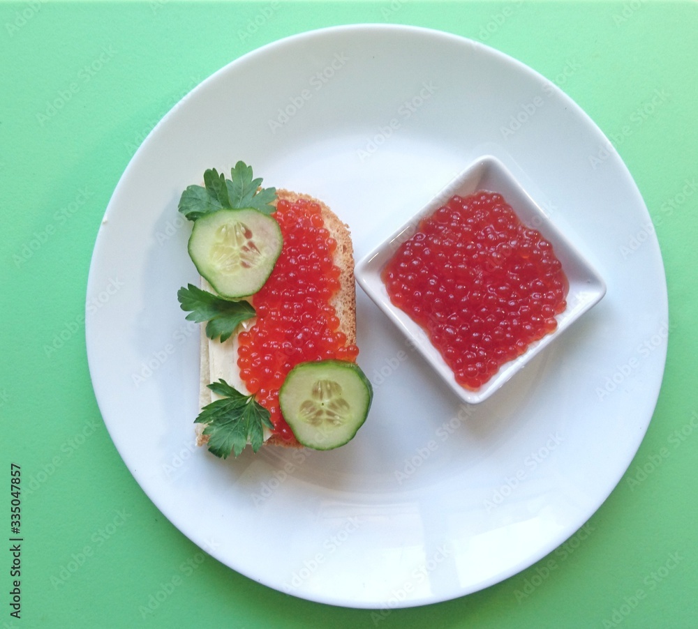 Red caviar of salmon fish, sandwich, cucumber, parsley. Red caviar of salmon fish, sandwich, cucumber, parsley.