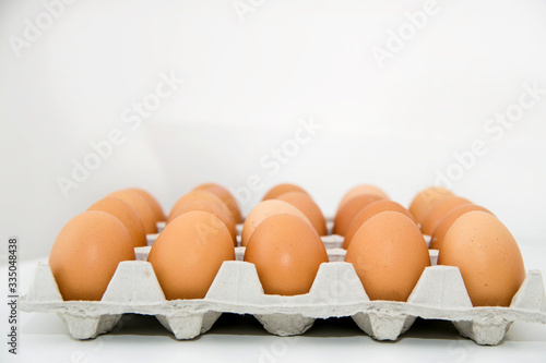 Chicken eggs in the package on a white background.