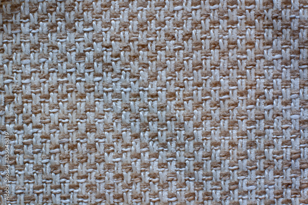 The texture of the fabric. White and brown checkered fabric. Copy space. The texture of the fabric. White and brown checkered fabric. Copy space.