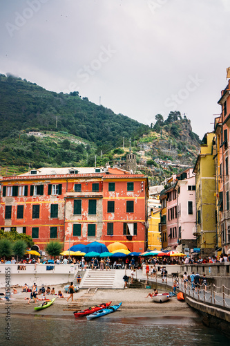Beautiful view of the beach in Vernazza, with colorful buildings and mountains in the background. Mediterranean landscape. 