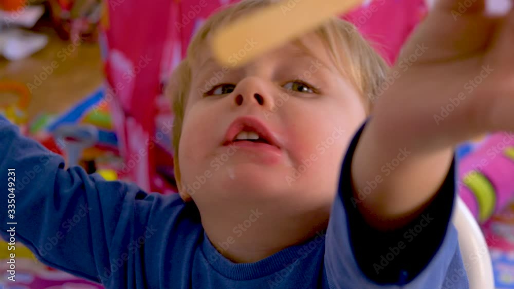 BLOND BOY WITH BLUE EYES EATING A CREAM AND CHOCOLATE ICE CREAM BLOND BOY WITH BLUE EYES EATING A CREAM AND CHOCOLATE ICE CREAM