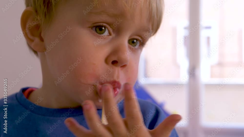 BLOND BOY EATING A CREAM AND CHOCOLATE ICE CREAM BLOND BOY EATING A CREAM AND CHOCOLATE ICE CREAM