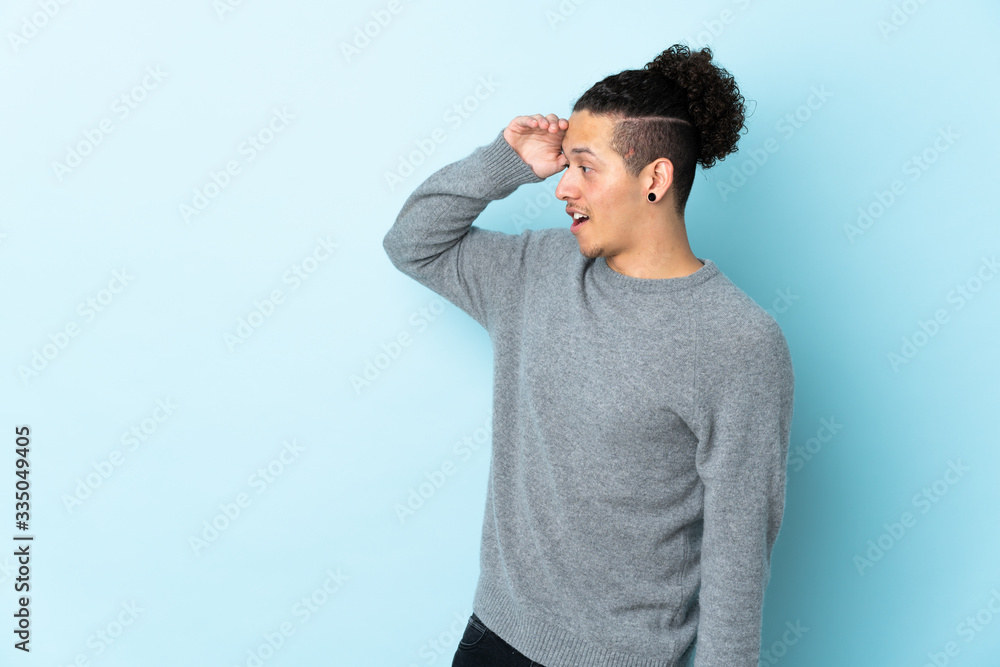 Caucasian man over isolated background with surprise expression while looking side Caucasian man over isolated background with surprise expression while looking side