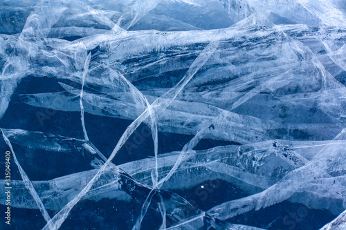 The natural texture of cracked ice of Lake Baikal. Clear blue ice. Layered thick ice. Horizontal. © Vladimir Kazakov