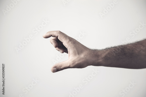 Tableau sur toile Fingers on the palm on a gray background. Hand sign.