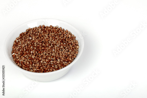 buckwheat in a white plate on a white background