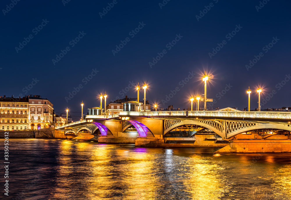 Night view of Blagoveshchensky drawbridge with an evening of multi-colored changing illumination. Saint Petersburg, Russia