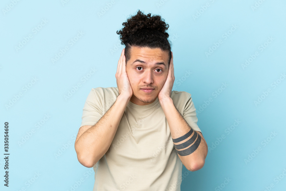 Caucasian man over isolated background frustrated and covering ears Caucasian man over isolated background frustrated and covering ears