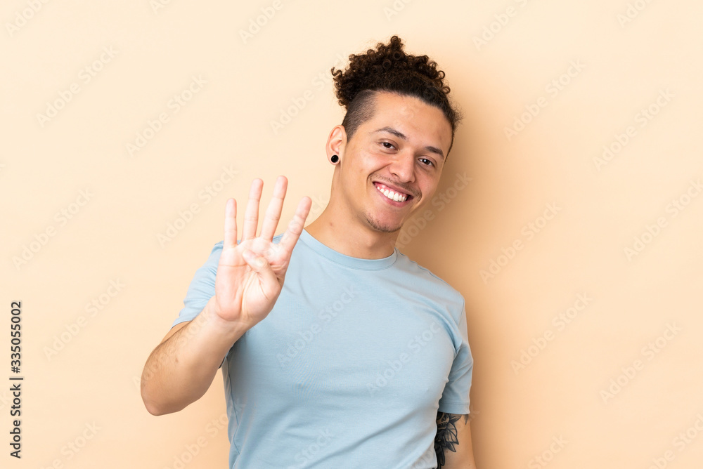 Caucasian man over isolated background happy and counting four with fingers Caucasian man over isolated background happy and counting four with fingers