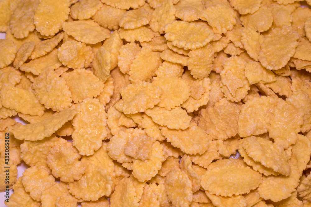 Honey crunchy flakes, solid background, photographed from above Honey crunchy flakes, solid background, photographed from above