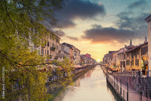 Fototapeta Naklejka Na Ścianę i Meble -  Naviglio Grande canal at sunset,on the sides of the canal the typical bars, restaurants and typical shops of the 