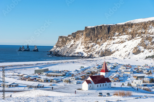 Picturesque aerial  view of Vik I Myrdal church at the top of the hill in Iceland in winter. Panoramic beautiful view of village Vik and Myrdal church in winter in Iceland 
