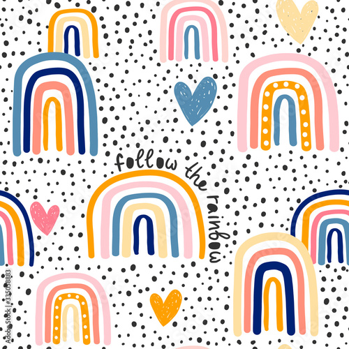 Childish seamless pattern with hand drawn rainbow, hearts and dots. Trendy kids vector background.