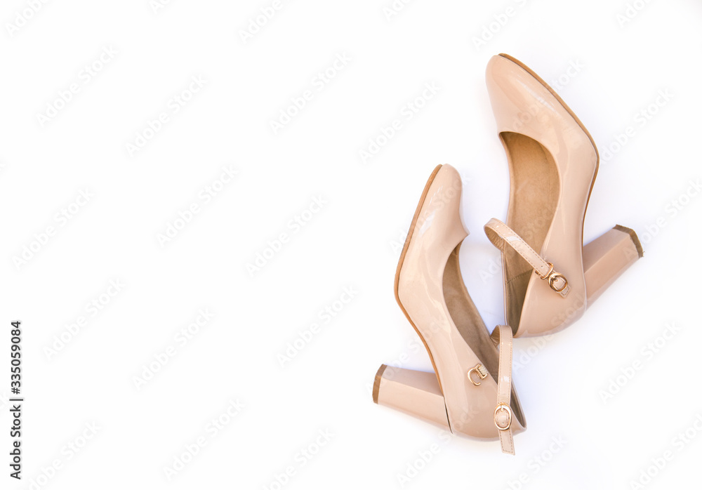 Pale pink female high heel shoes on a white background. Flat lay, top view of fashionable beauty female background. Pale pink female high heel shoes on a white background. Flat lay, top view of fashionable beauty female background.