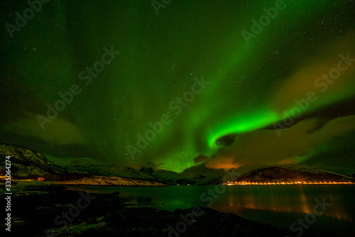Dramatic polar lights, Aurora borealis over the mountains in the North of Europe - Lofoten islands, Norway © Tatiana