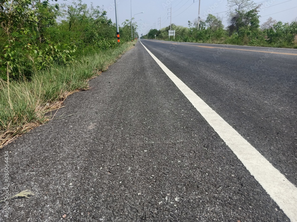 Asphalt road in Thailand and white traffic line