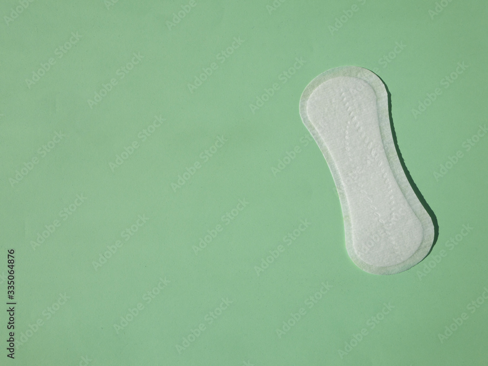Close up view of woman's sanitary pad on color back. Top view. Close up view of woman's sanitary pad on color back. Top view.