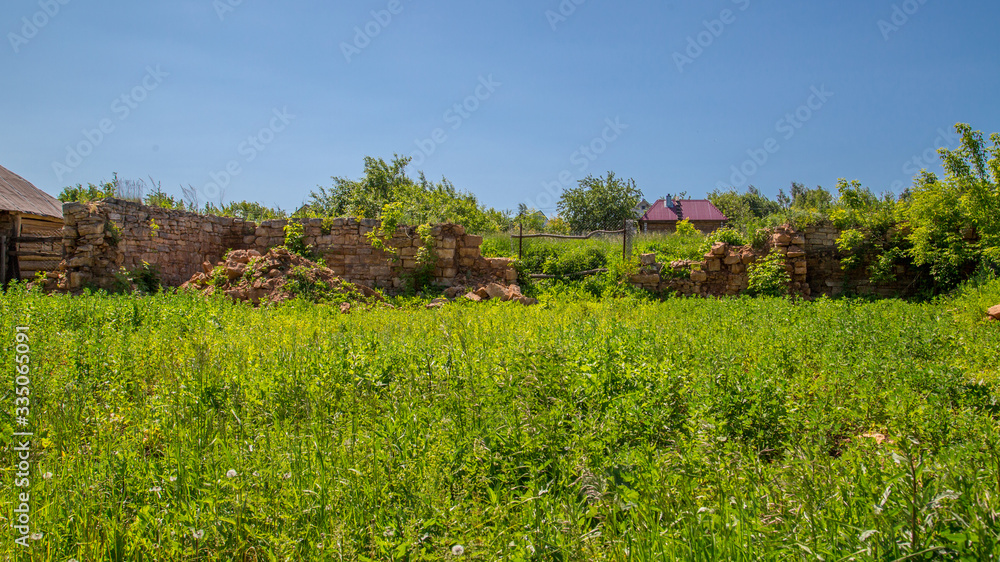 destroyed stone walls in the village