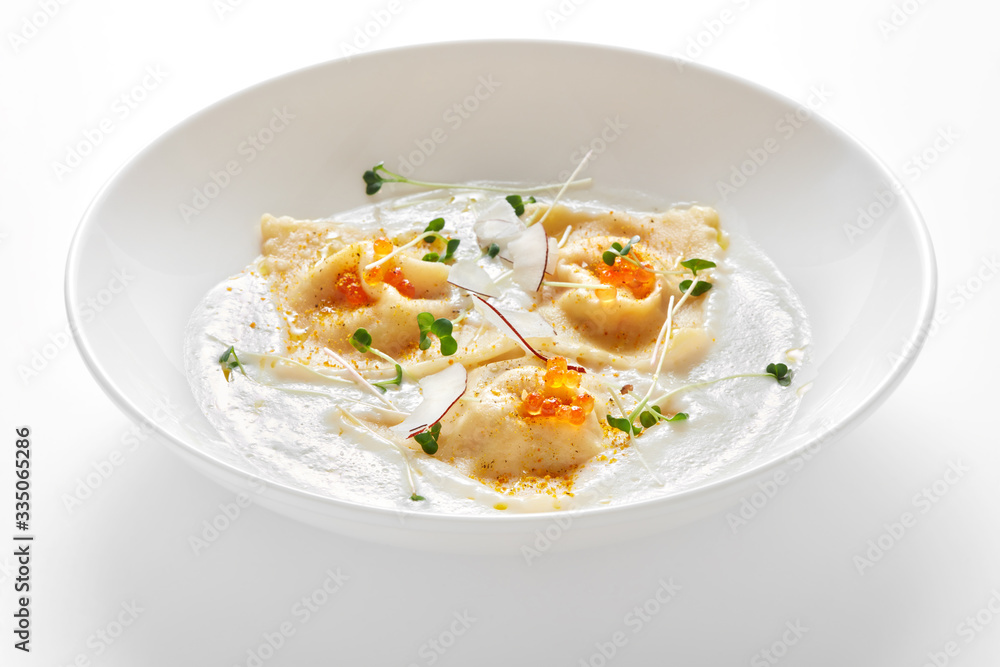 bowl with ravioli with caviar in cream sauce isolated on white background bowl with ravioli with caviar in cream sauce isolated on white background