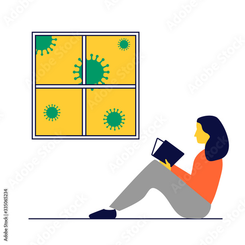 Cuarentena en casa. Chica leyendo en la ventana. Chica leyendo en casa durante la pandemia del Coronavirus.