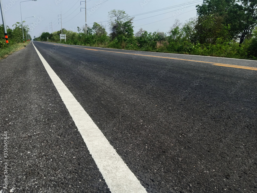 Asphalt road in Thailand and white traffic line Asphalt road in Thailand and white traffic line